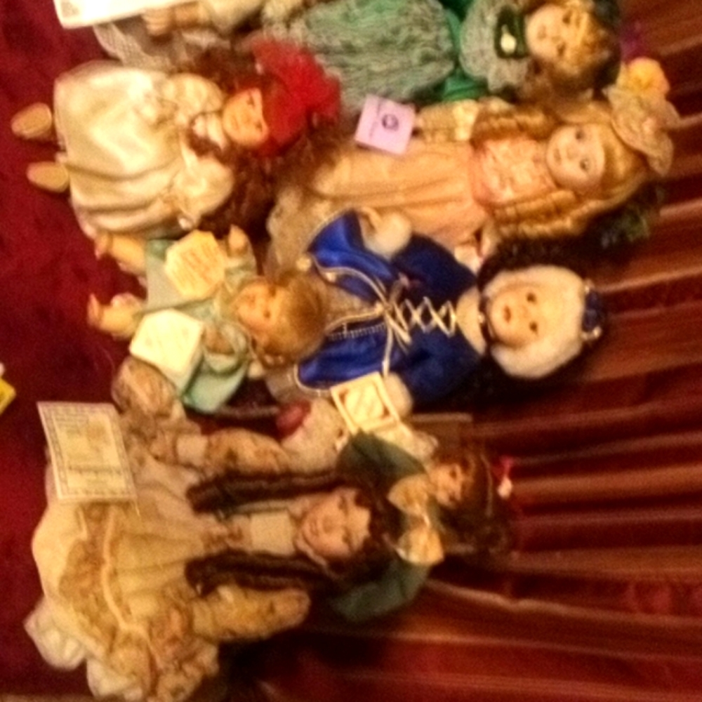 Variety of porcelain dolls with authenticity certificates